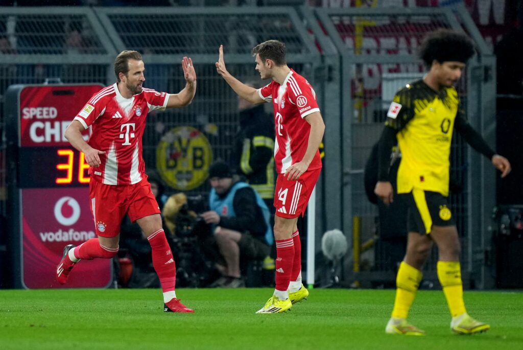 DORTMUND, GERMANY - FEBRUARY 28: Harry Kane of FC Bayern Munich celebrates scoring his team's first goal with teammate Josip Stanisic during the Bundesliga match between Borussia Dortmund and FC Bayern München at Signal Iduna Park on February 28, 2026 in Dortmund, Germany. (Photo by Pau Barrena/Getty Images)