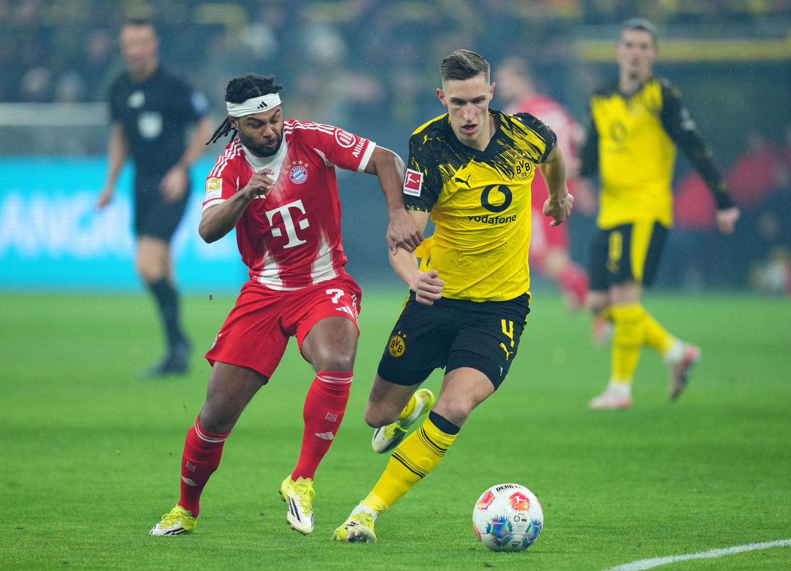 DORTMUND, GERMANY - FEBRUARY 28: Serge Gnabry of FC Bayern Munich battles for possession with Nico Schlotterbeck of Borussia Dortmund during the Bundesliga match between Borussia Dortmund and FC Bayern München at Signal Iduna Park on February 28, 2026 in Dortmund, Germany. (Photo by Pau Barrena/Getty Images)