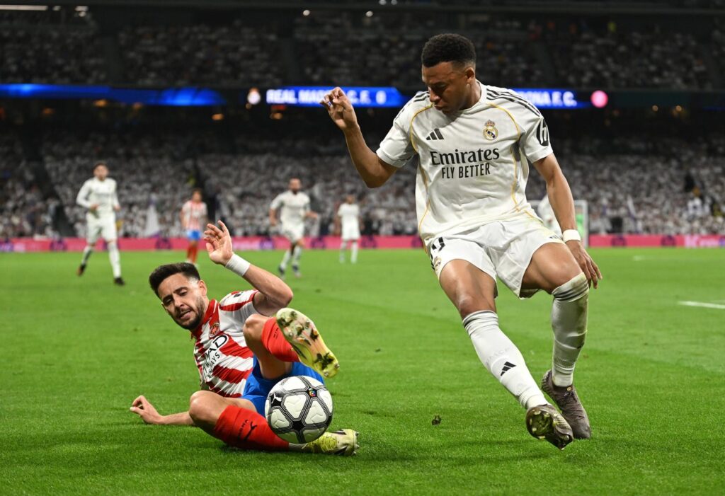 MADRID, SPAIN - APRIL 10: Kylian Mbappe of Real Madrid is challenged by Alex Moreno of Girona FC during the LaLiga EA Sports match between Real Madrid CF and Girona FC at Estadio Santiago Bernabeu on April 10, 2026 in Madrid, Spain. (Photo by Denis Doyle/Getty Images