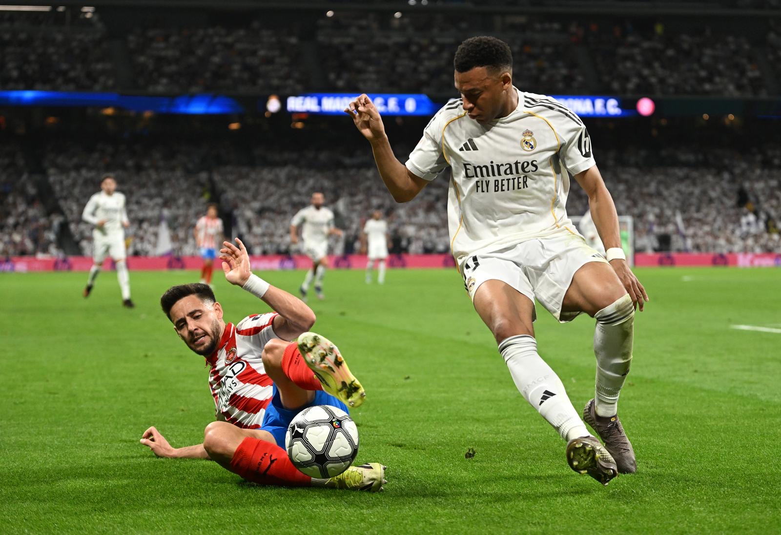 MADRID, SPAIN - APRIL 10: Kylian Mbappe of Real Madrid is challenged by Alex Moreno of Girona FC during the LaLiga EA Sports match between Real Madrid CF and Girona FC at Estadio Santiago Bernabeu on April 10, 2026 in Madrid, Spain. (Photo by Denis Doyle/Getty Images